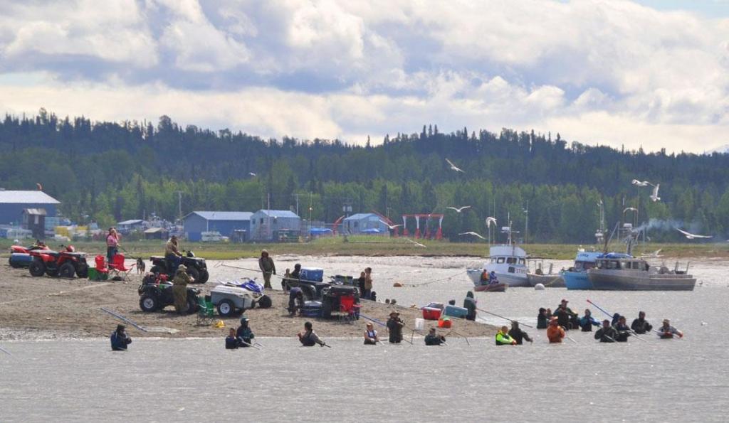 Alaskan residents and fishermen dip netting from 